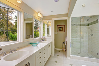 Spacious bright bathroom with glass door shower